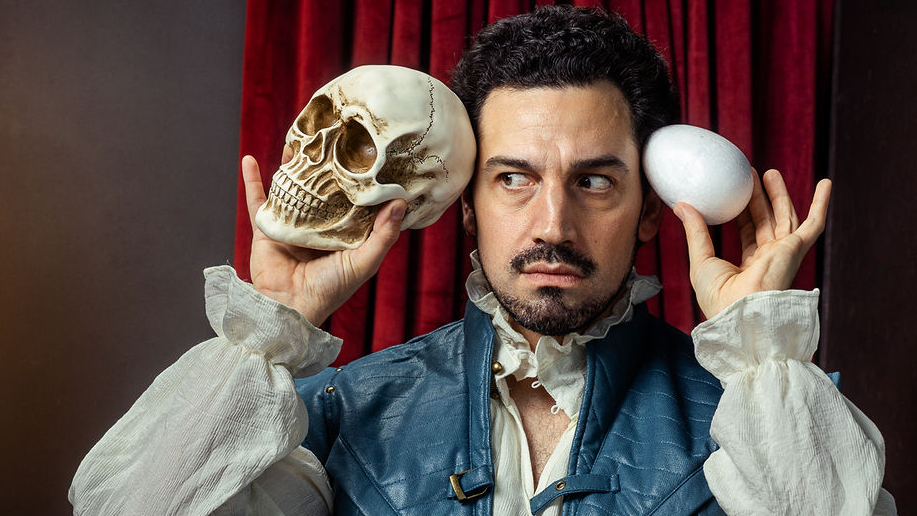 Image of a man holding a skull and an egg.
